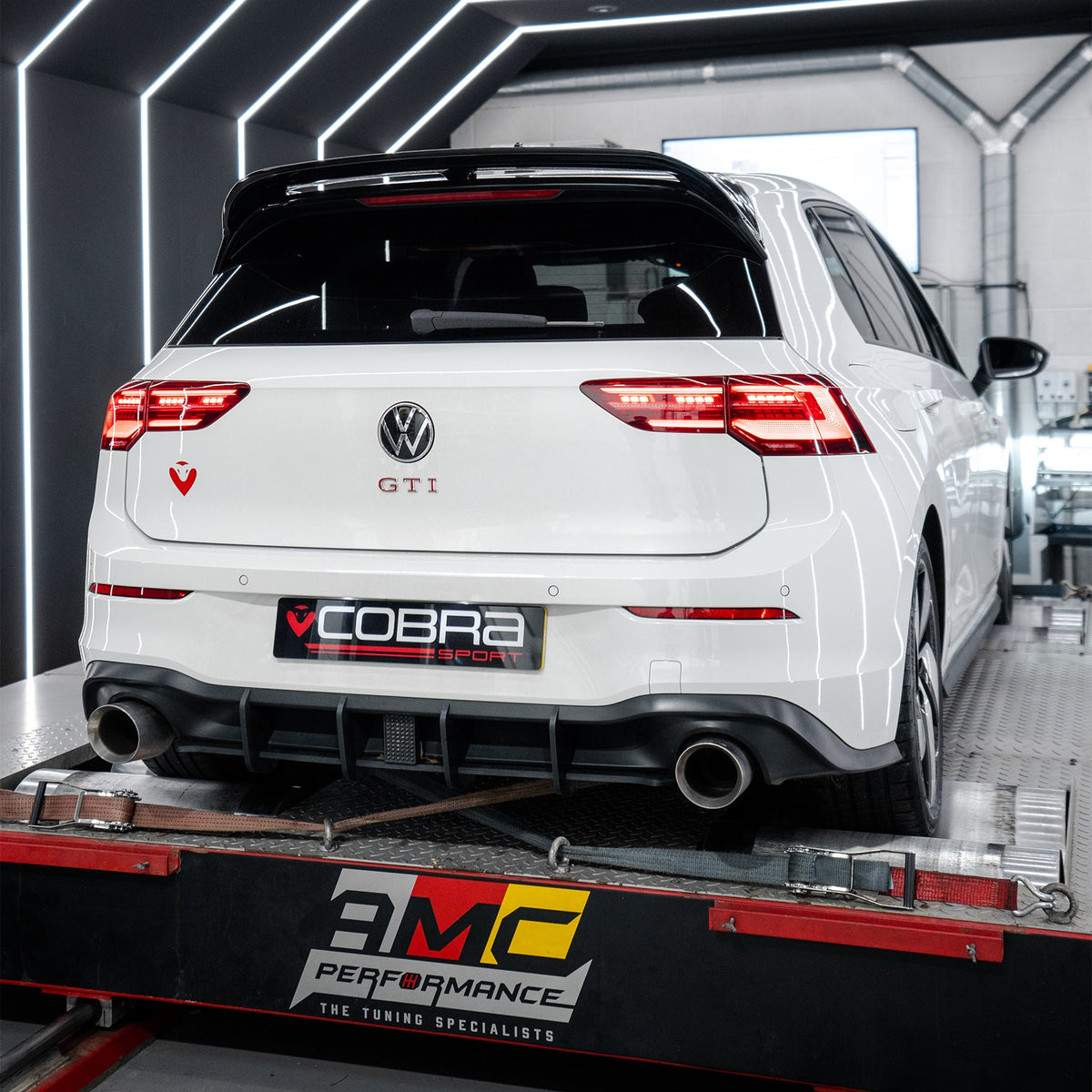 Cobra Sport VW Golf GTI Mk8 2.0 TSI front downpipe sports cat and de-cat performance exhaust system installed on a car.