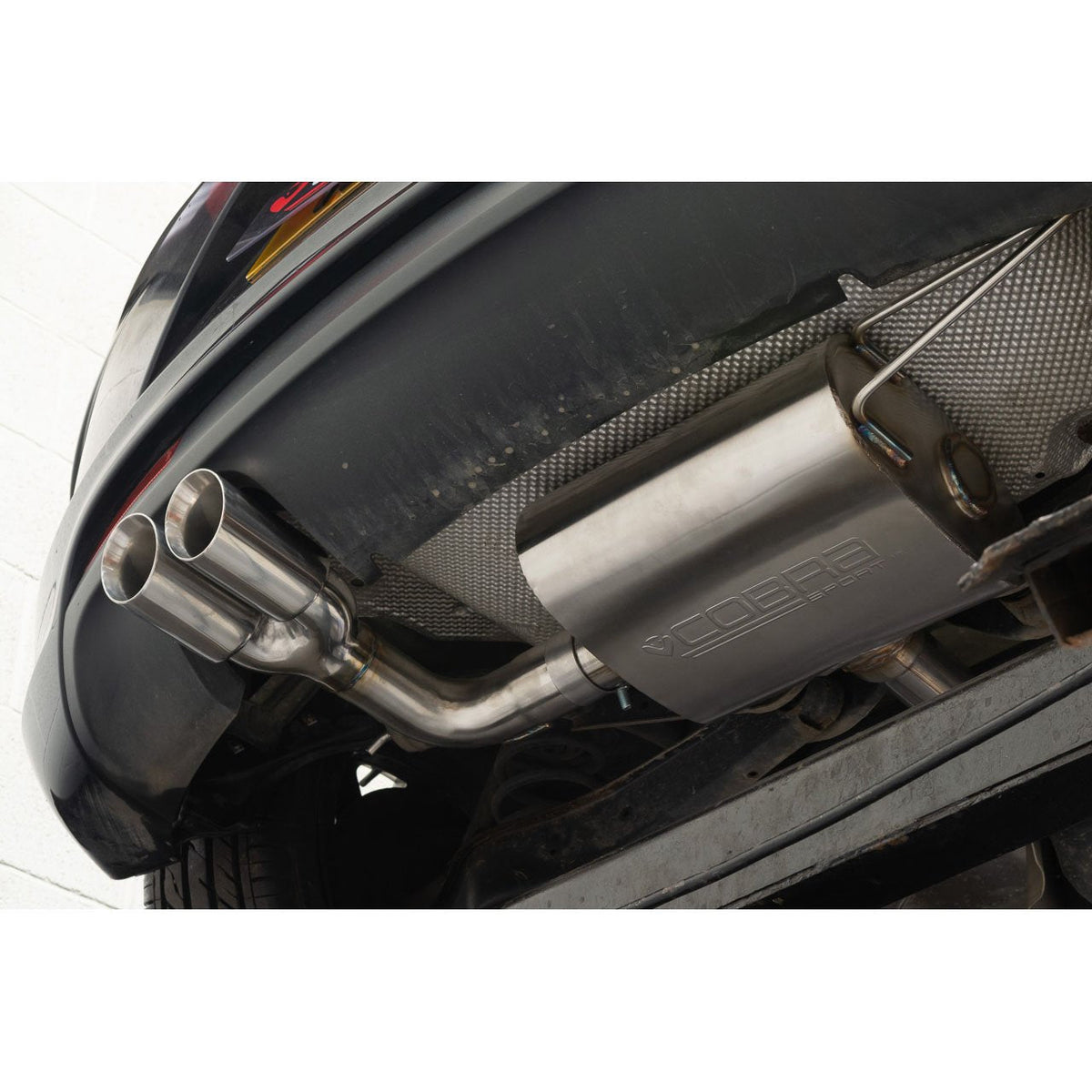 Volkswagen Scirocco R-Line with Cobra Sport cat back performance exhaust system installed, showcasing polished metal exhaust pipes.