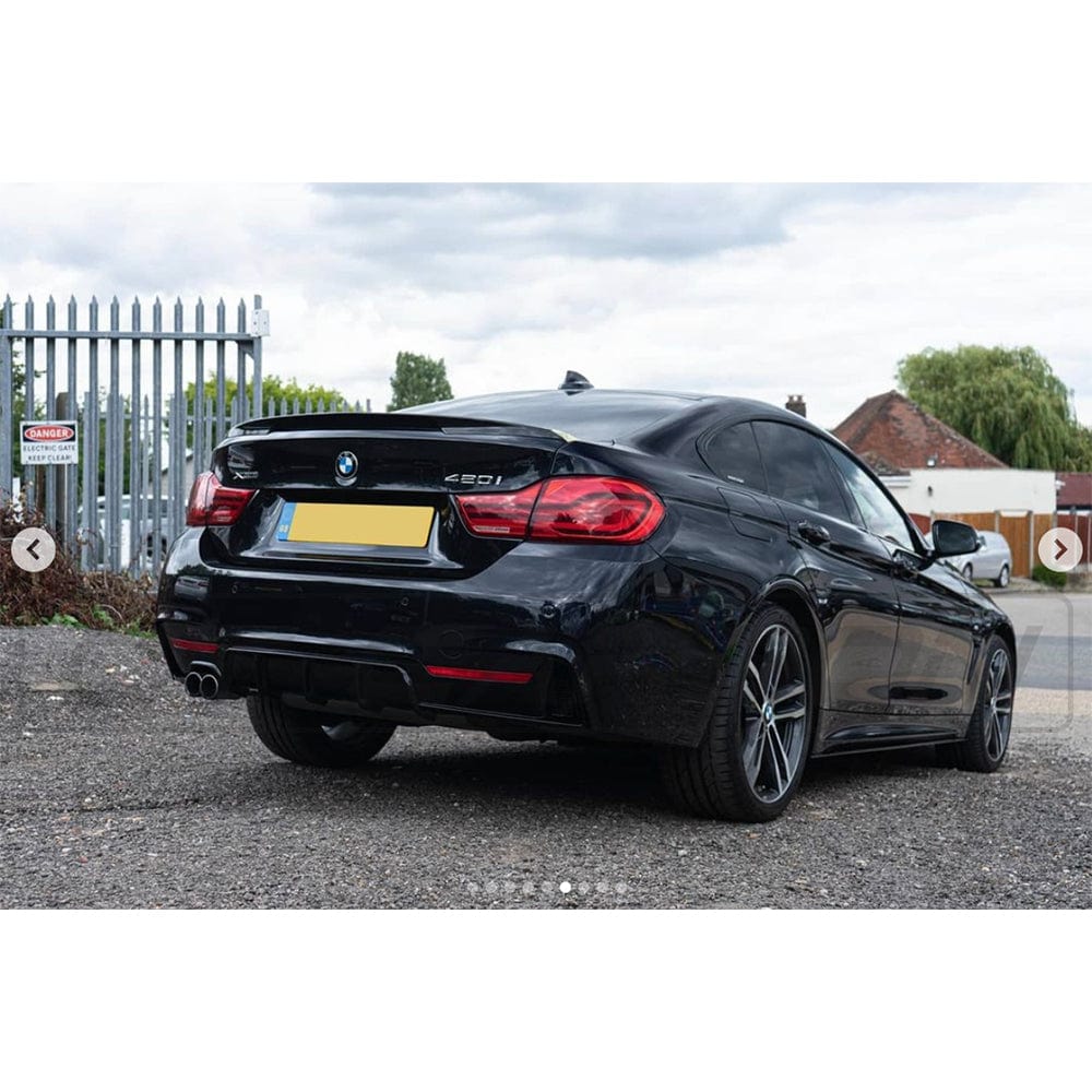 BMW 4 Series F32/F33/F36 GLOSS BLACK twin left exhaust diffuser by CT Carbon, showcasing sleek black finish and dual exhaust outlets.