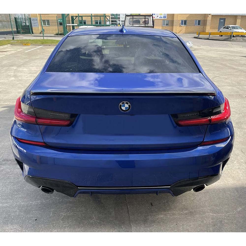 BMW 3 Series G20 gloss black full kit with round exhaust by CT Carbon, featuring sleek black finish and MP-style exhaust exit.