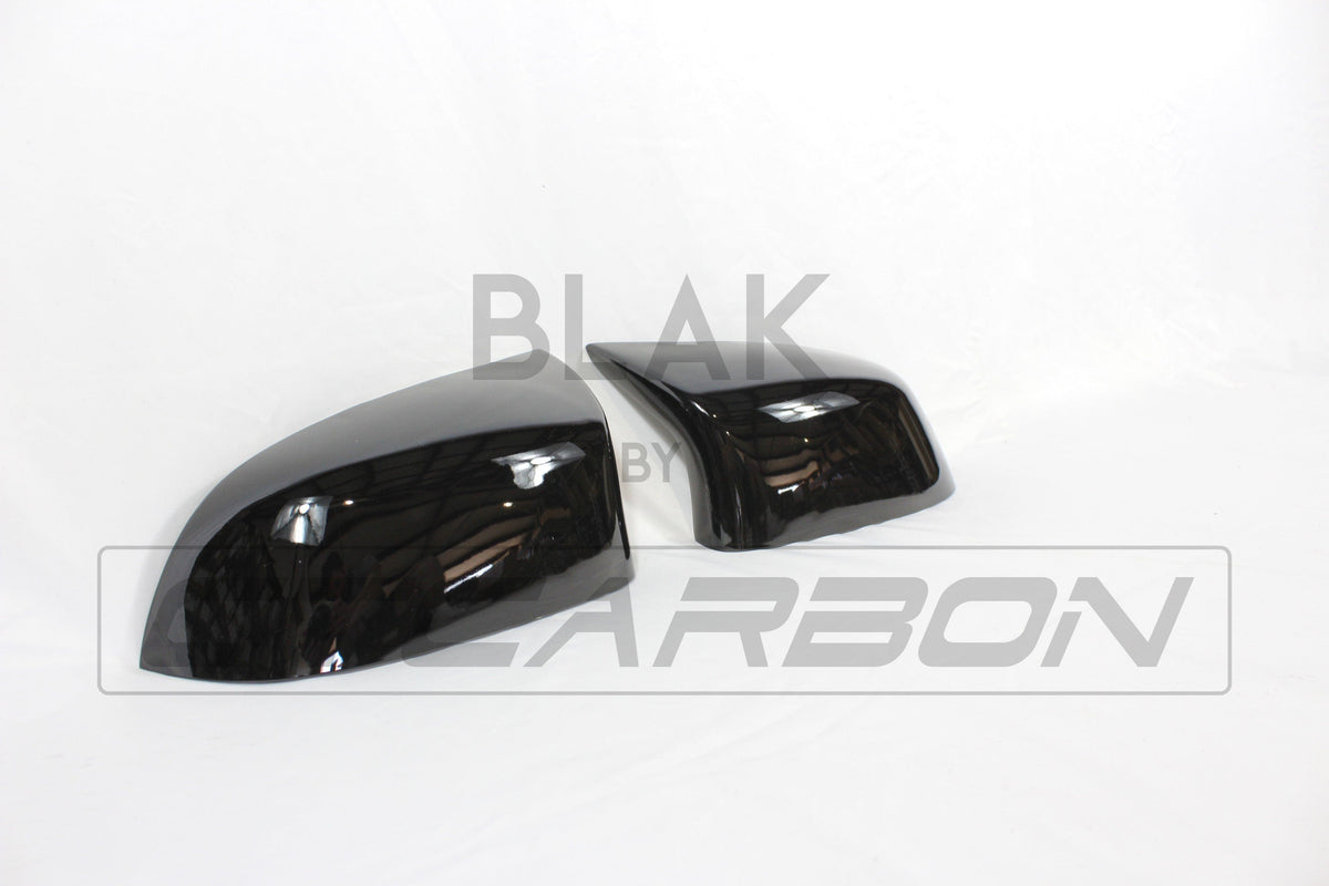 Gloss black mirror replacements for BMW F15/F16 X5/X6 from CT Carbon, featuring sleek, reflective mirror covers for 2014-2018 models.