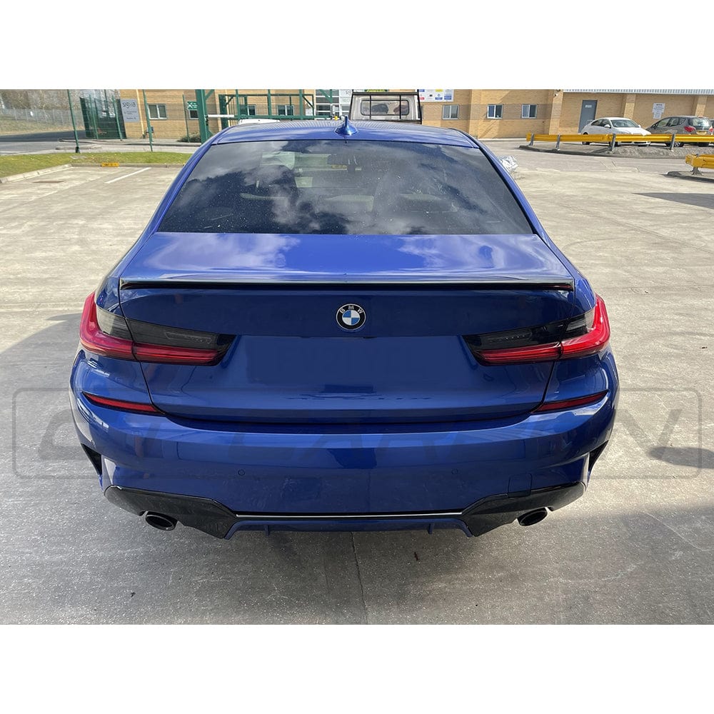 Gloss black BMW 3 Series G20 M3 G80 spoiler by CT Carbon, showing a sleek, aerodynamic design on a black vehicle.