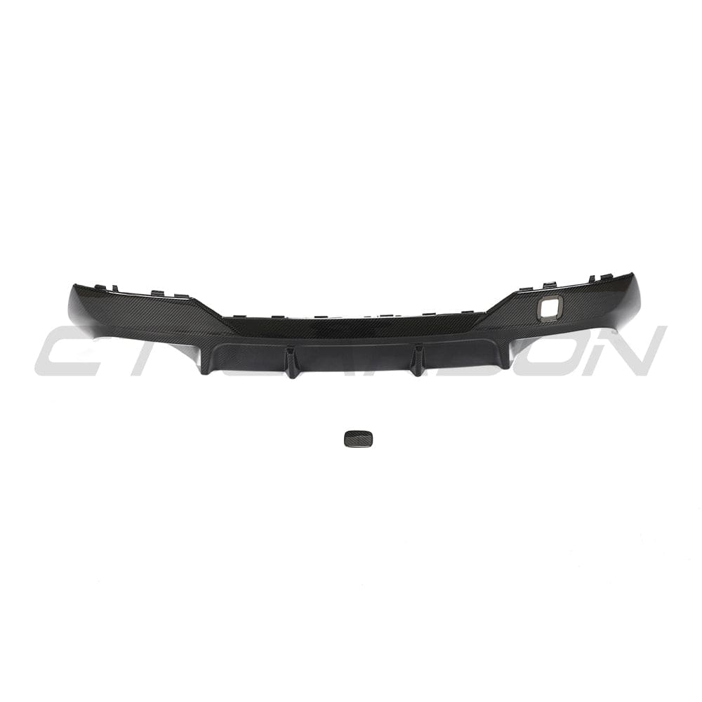 Black carbon fibre diffuser kit for BMW G22 4 Series by CT Carbon, showcasing sleek, textured carbon fibre details.