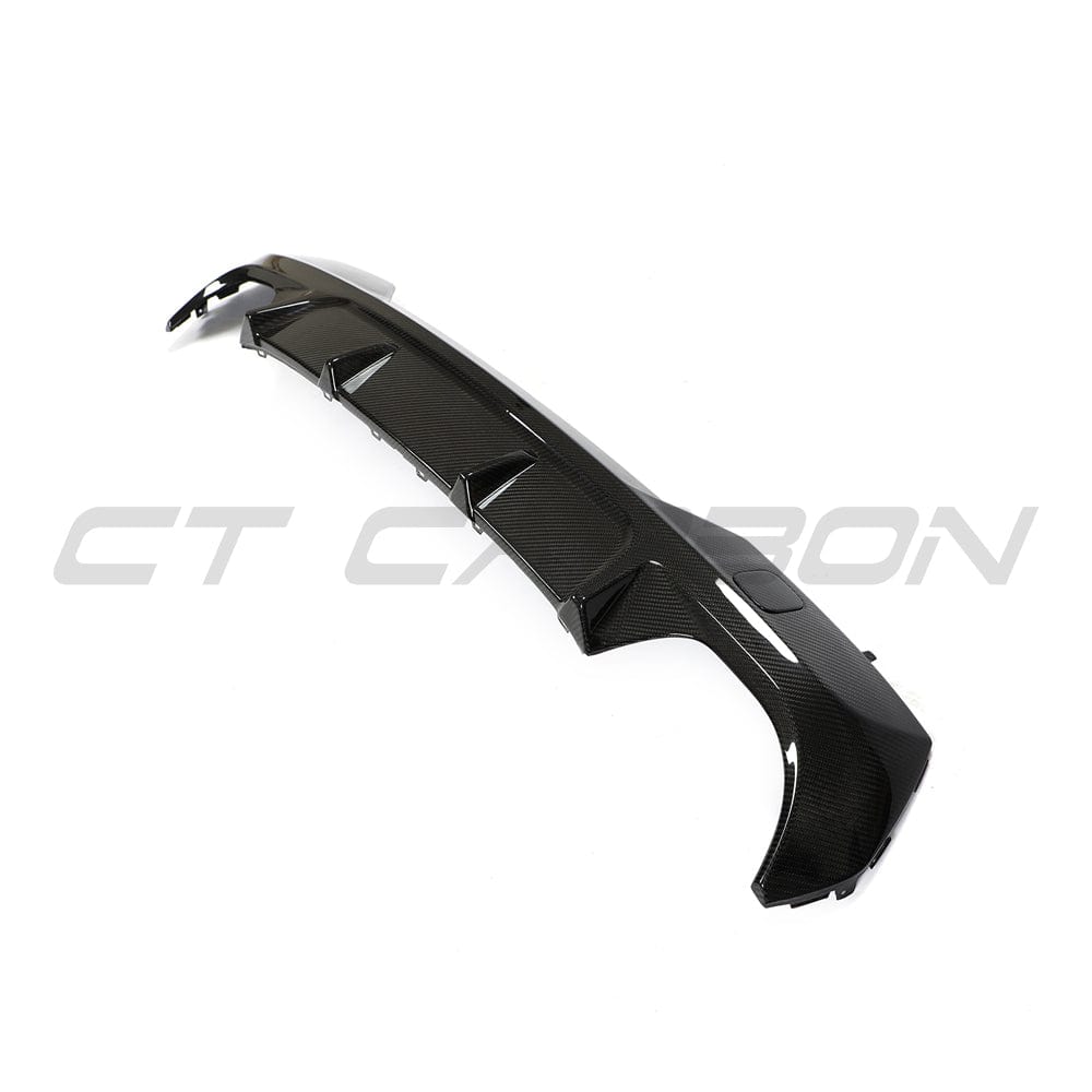 Black BMW G22 4 Series carbon fibre diffuser kit by CT Carbon, showcasing sleek, lightweight, high-performance carbon fibre components.