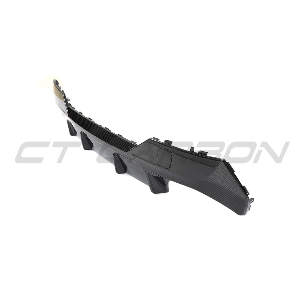 Black BMW G22 4 Series carbon fibre diffuser kit by CT Carbon, featuring a sleek, lightweight design for enhanced sporty appearance.