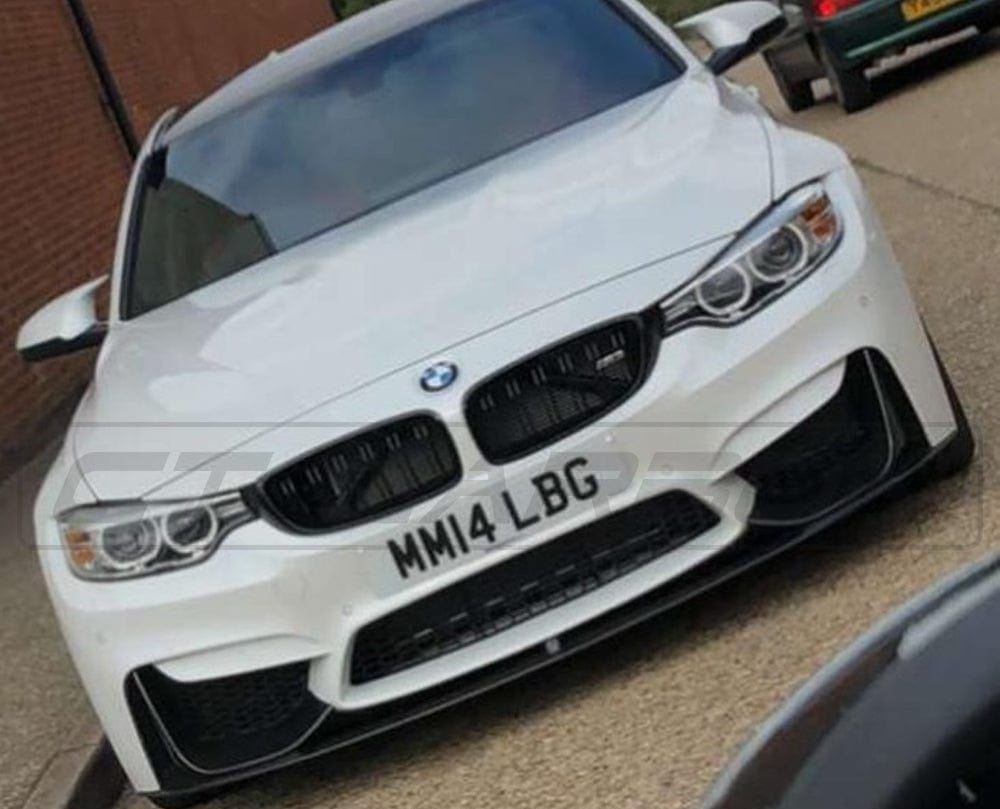 BMW M3 F80 double slat black grille by CT Carbon, close-up view of sleek black grille with carbon accents on vehicle.
