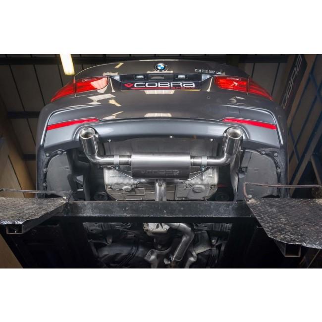 Cobra Sport BMW 335D F30 dual exit exhaust conversion with stylish dual tailpipes on a dark vehicle.