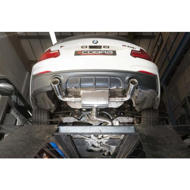 Cobra Sport BMW M235i F22 cat back performance exhaust system with polished metal pipes and dual tailpipes visible.