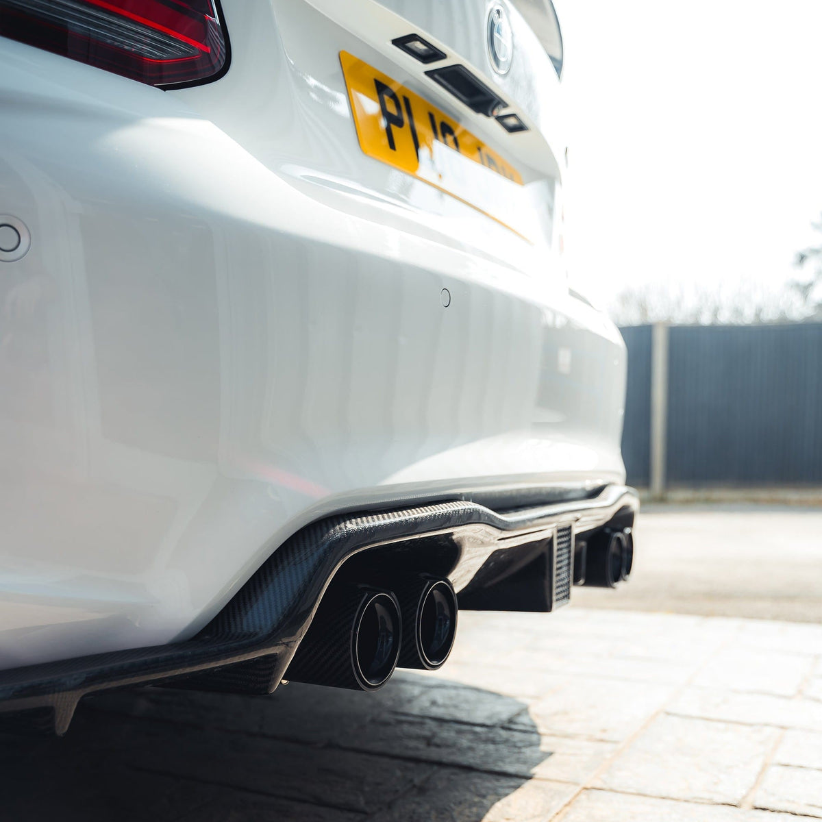 BMW M2 F87 carbon fibre diffuser by CT Carbon, K-style design, showcasing sleek aerodynamic features and lightweight construction.