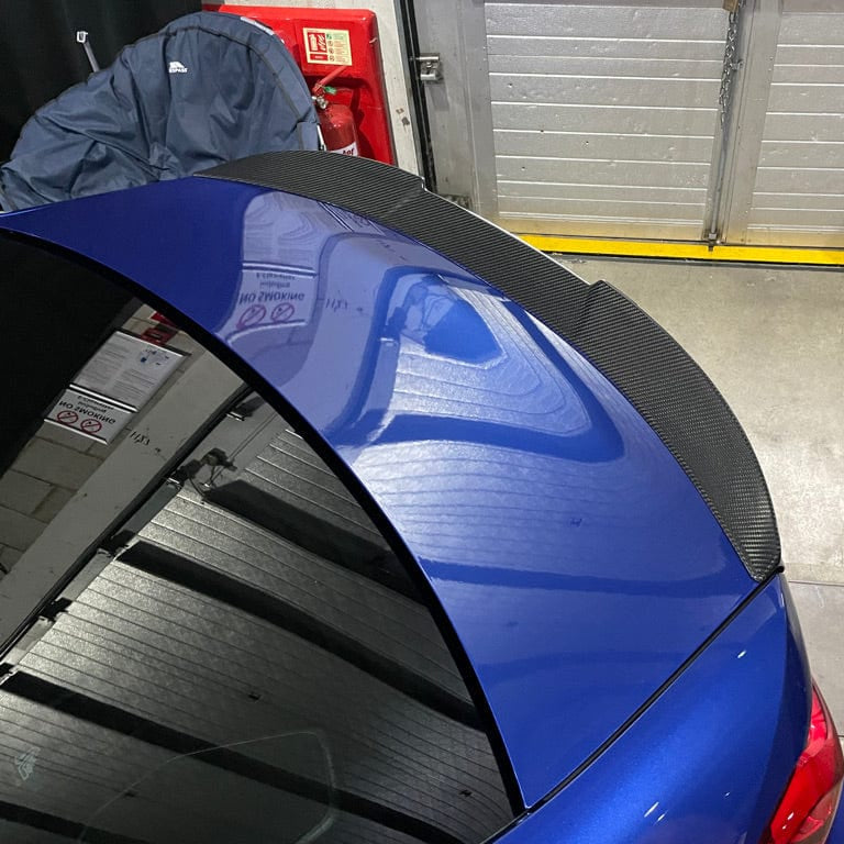 BMW G82 M4 full carbon fiber kit by CT Carbon, showing front bumper, side skirts, and rear diffuser in a high-quality image.
