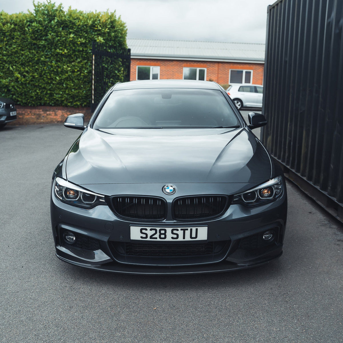 BMW F32 4 Series Coupe with CT Carbon full carbon fibre kit including splitter and twin exhaust, showcasing sleek, lightweight design.