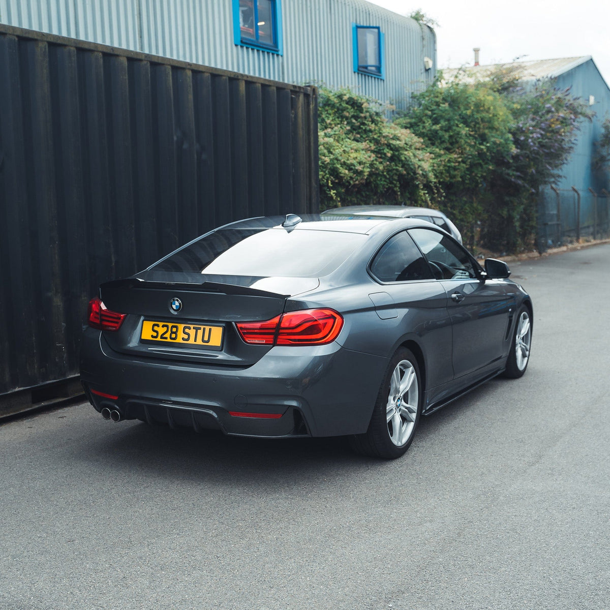 BMW F32 4 Series Coupe full carbon fiber kit with splitter and twin exhaust, designed by CT Carbon for a sporty, aerodynamic look.