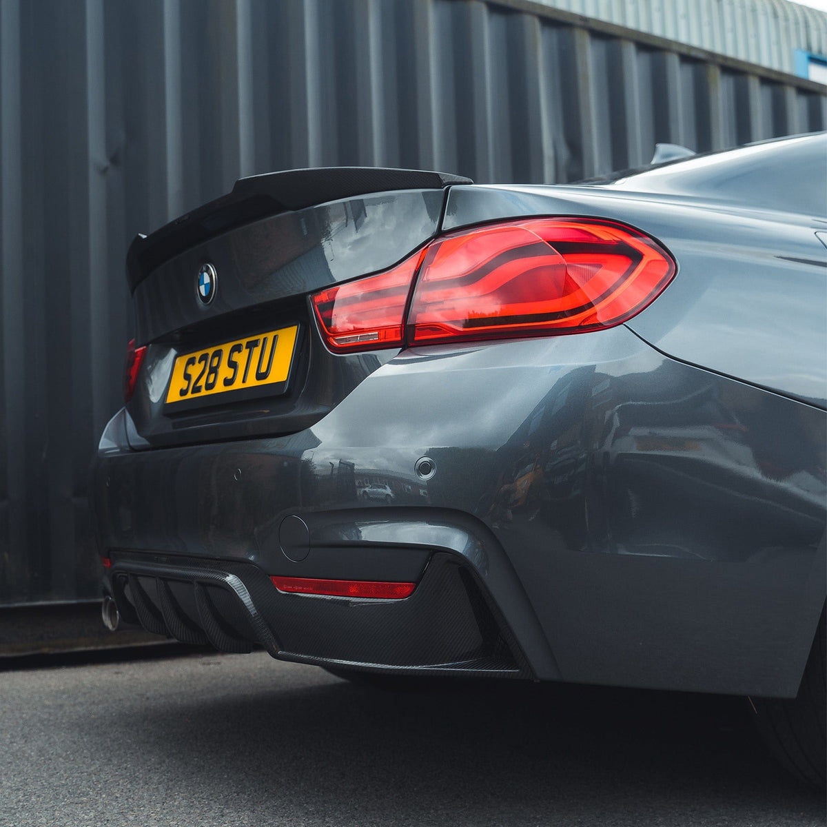 BMW F32 4 Series Coupe full carbon fiber kit by CT Carbon with twin exhaust, including front splitter and aerodynamic enhancements.