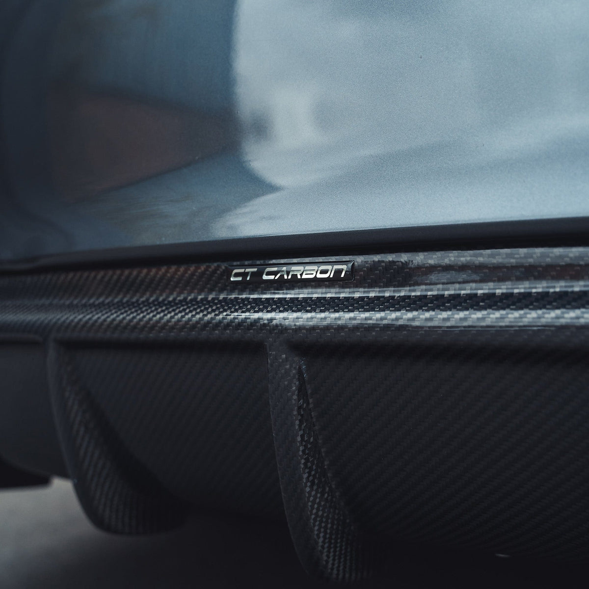 BMW F32 4 Series Coupe full carbon fibre kit with twin exhaust, showing splitter and sleek carbon fiber details by CT Carbon.