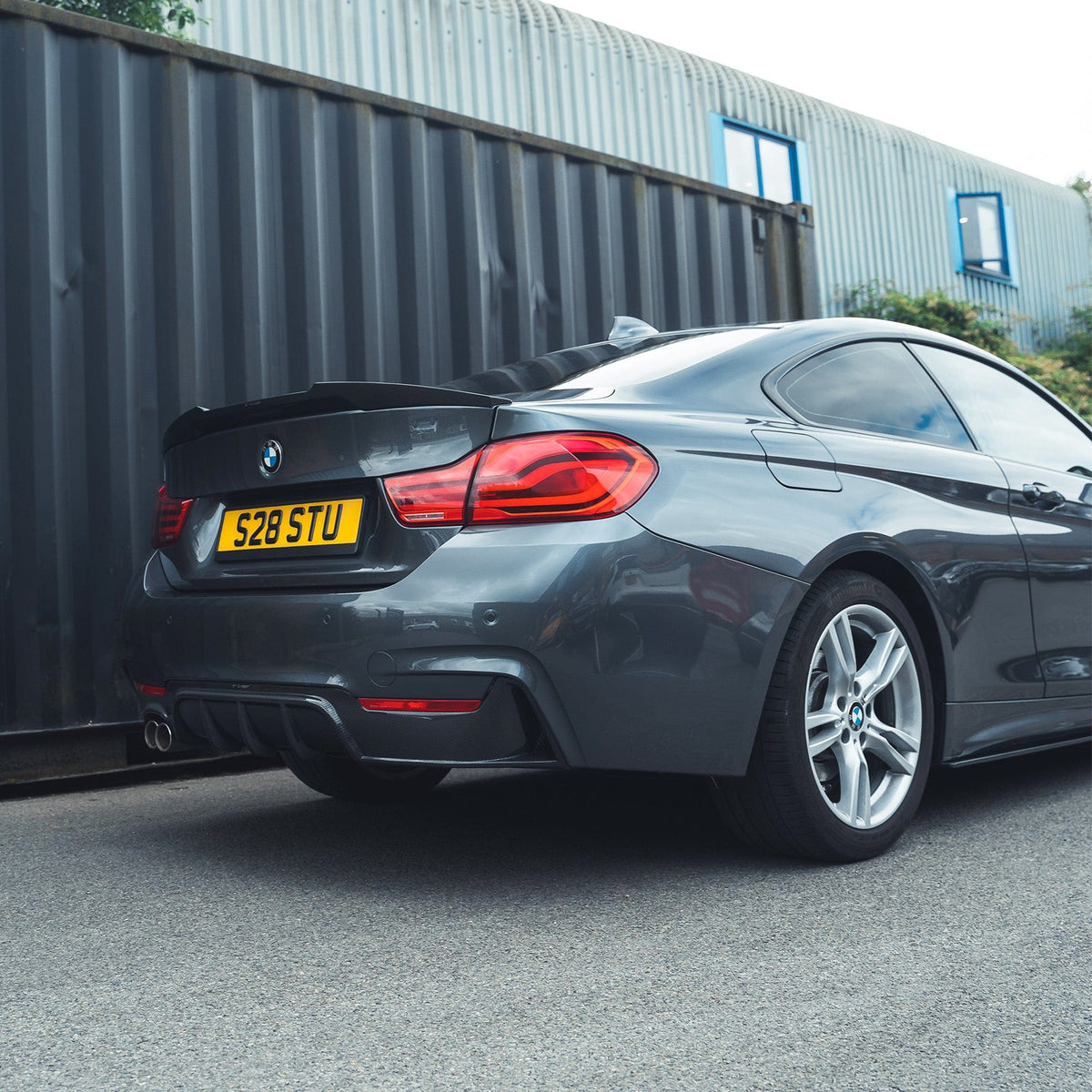 Full BMW F32 4 Series Coupe with CT Carbon full carbon fiber kit, featuring splitter and twin exhaust, showcasing sporty aerodynamic design.