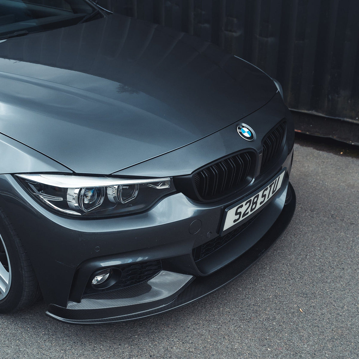 BMW F32 4 Series Coupe full carbon fiber kit with splitter and twin exhaust, designed by CT Carbon, showcasing sleek aerodynamic components.