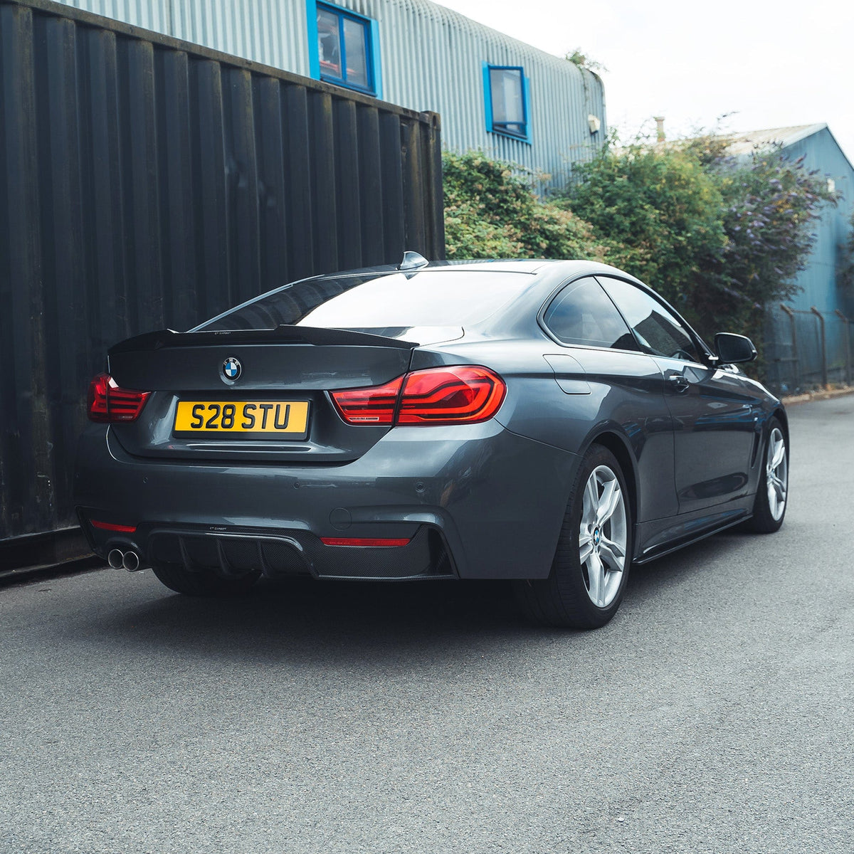 BMW F32 4 Series Coupe full carbon fiber kit by CT Carbon, showing splitters and aerodynamic components with twin exhaust.