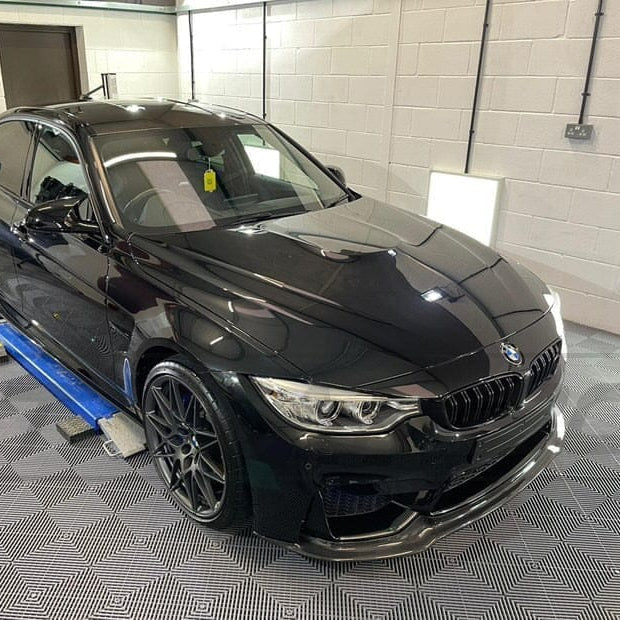 Full view of a BMW M3 F80 saloon with CT Carbon V3 full carbon fibre kit, including splitter and body accents, showcasing sleek carbon details.