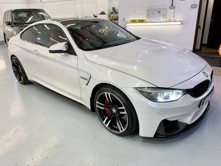 Full view of a BMW M4 F83 convertible with CT Carbon full carbon fiber kit, showcasing carbon splitter and body enhancements.