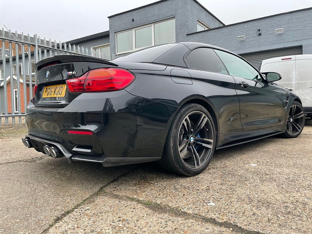 Full view of a BMW M4 (F83) convertible with CT Carbon full carbon fibre kit, showcasing the carbon fibre splitter and body accents.