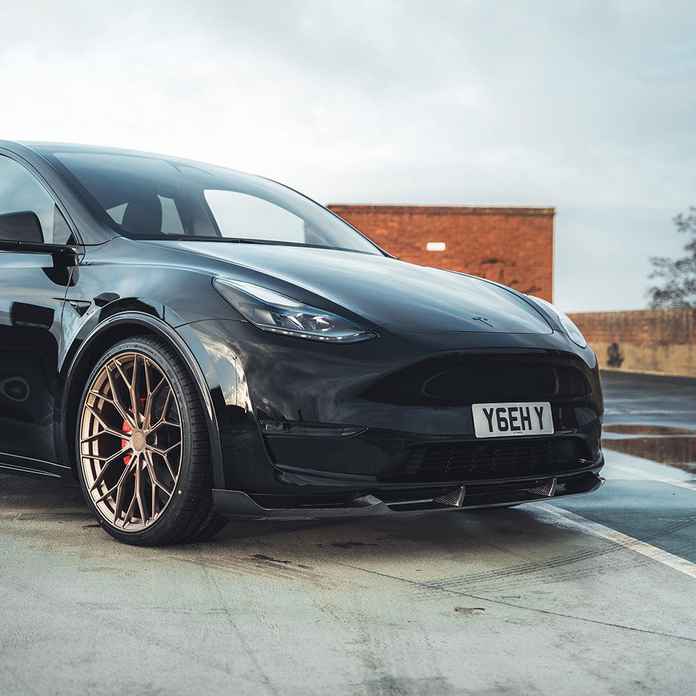Tesla Model Y MK1 2020-2025 carbon fibre splitter by CT Carbon, showing sleek aerodynamic front splitter with textured carbon fiber finish.