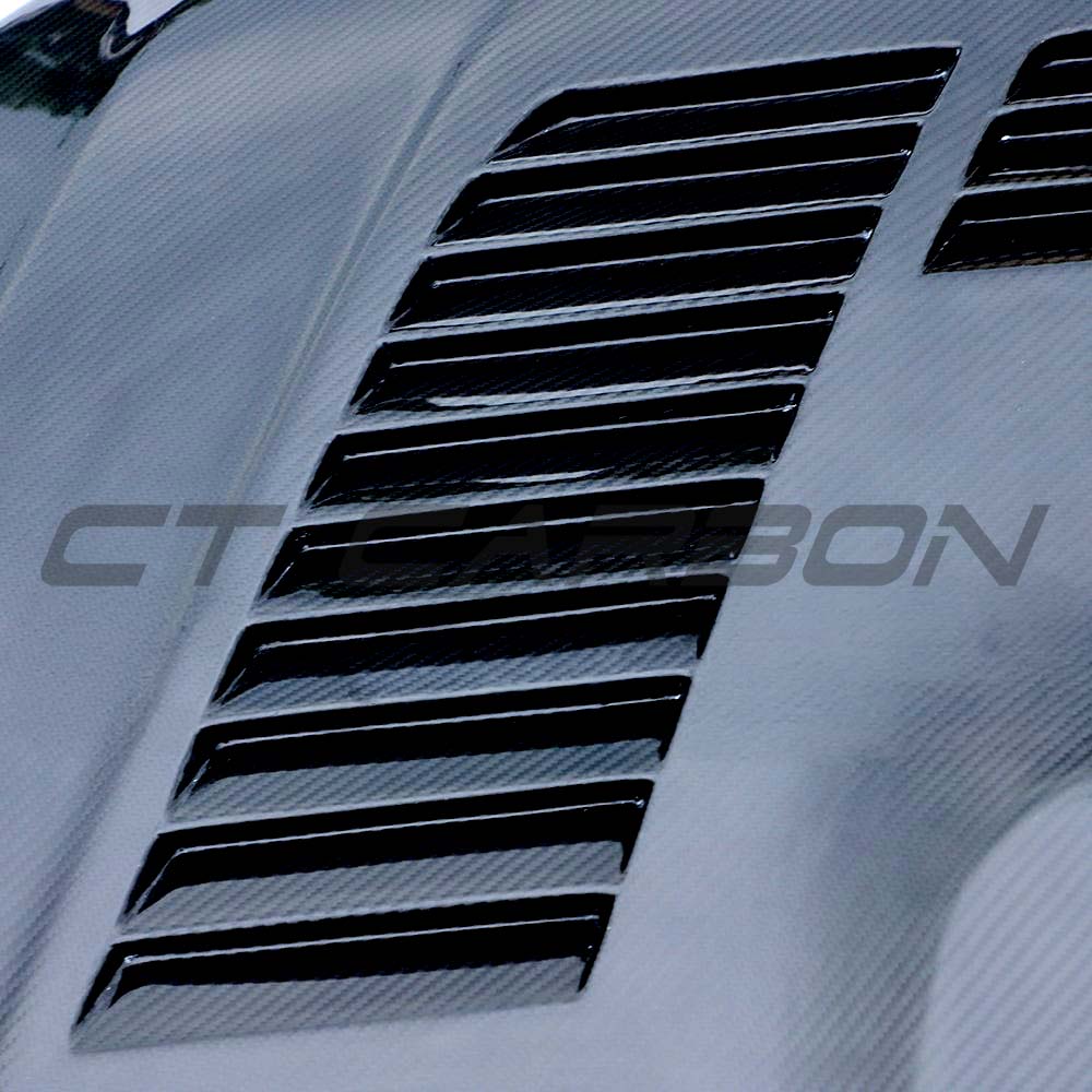 BMW M2 F87 and F20/F22 carbon fiber bonnet by CT Carbon, showcasing lightweight, glossy black carbon fiber surface on vehicle.