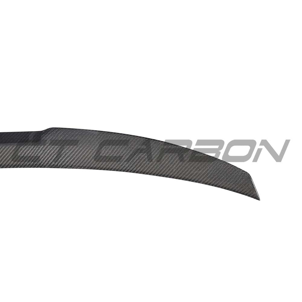 BMW M5 F90 and G30 5 Series carbon fibre spoiler by CT Carbon, M4 style, installed on the vehicle's rear for sporty enhancement.
