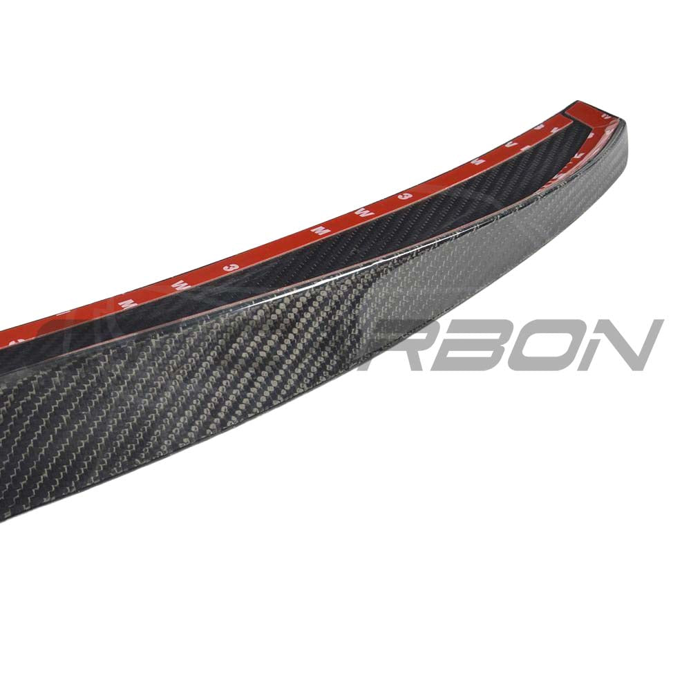 BMW M5 F90 and G30 5 Series carbon fiber spoiler by CT Carbon, M4 style, mounted on the vehicle, showcasing sleek aerodynamic design.