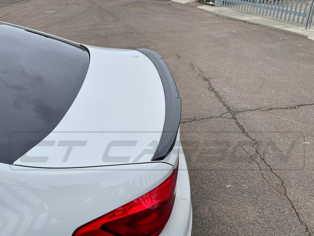 BMW M5 F90 and G30 5 Series CT Carbon fibre spoiler, M4 style, showcasing sleek, aerodynamic design on a black car.