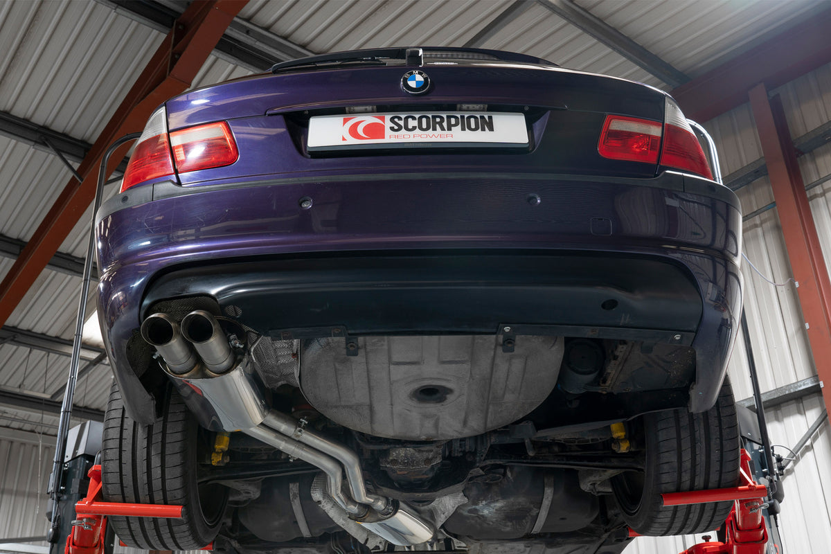 Scorpion BMW E46 cat-back exhaust system installed on coupe, showing polished metal pipes and muffler components.