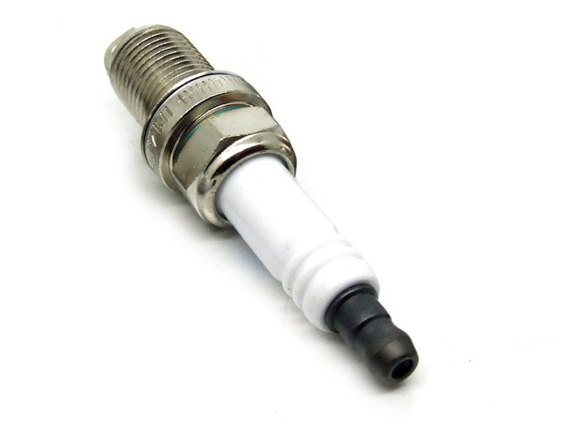 Genuine Porsche spark plug for Porsche 996 GT3 engine, showing the metal tip and ceramic insulator in a close-up view.