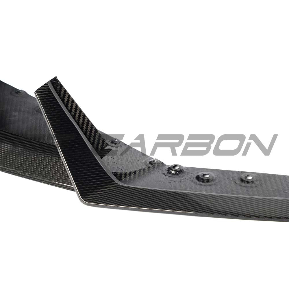 Carbon fiber Lamborghini Revueltto front splitter by CT Carbon, showcasing sleek aerodynamic design and high-performance automotive styling.