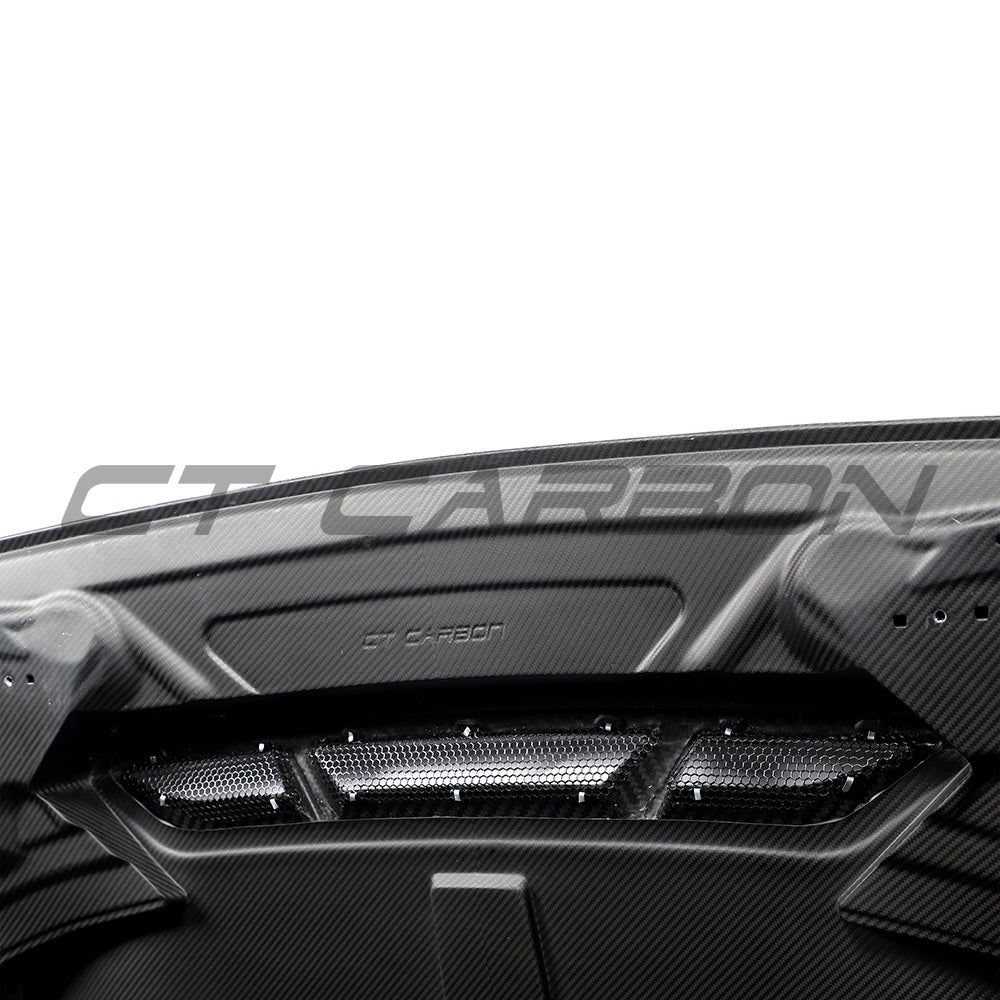 BMW F87 M2 and F20/F22 1 Series carbon fibre bonnet by CT Carbon, showing sleek, lightweight design with textured carbon fiber surface.