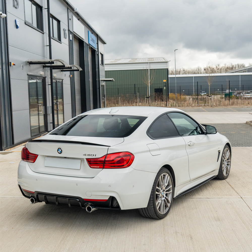 BMW 4 Series F32/F33/F36 CT Carbon gloss black dual exit exhaust diffuser V2, with sleek aerodynamic design and carbon finish.