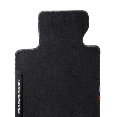 Genuine BMW F87 M Performance floor mats in black with embroidered M logo, designed for durable car interior protection.