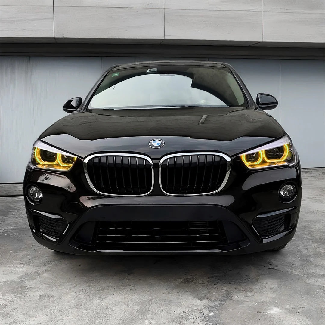 CT Carbon BMW F48 X1 2016-2019 pre-LCI yellow adaptive DRL module set installed on the vehicle.