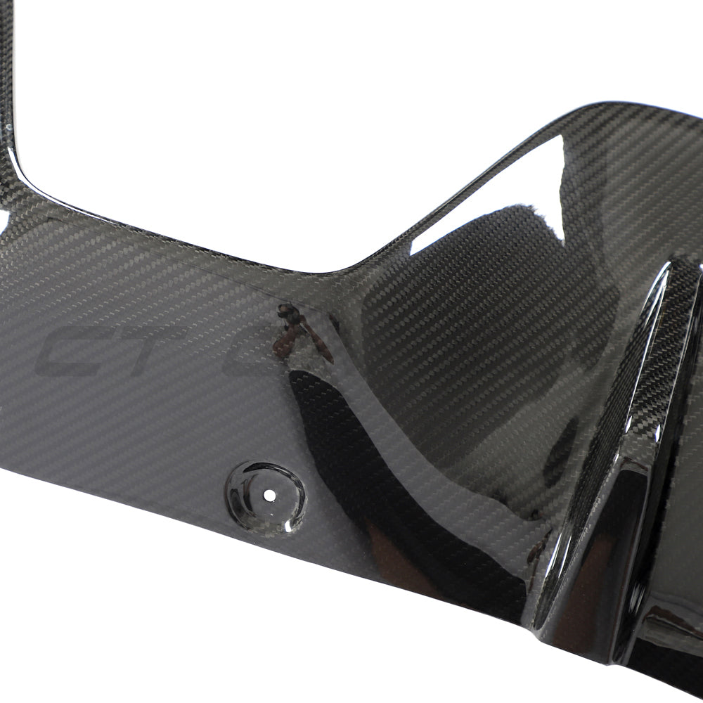 Toyota Supra 2019+ A90 CT Carbon diffuser add-on installed on the rear of the sports car, showcasing carbon fibre finish.