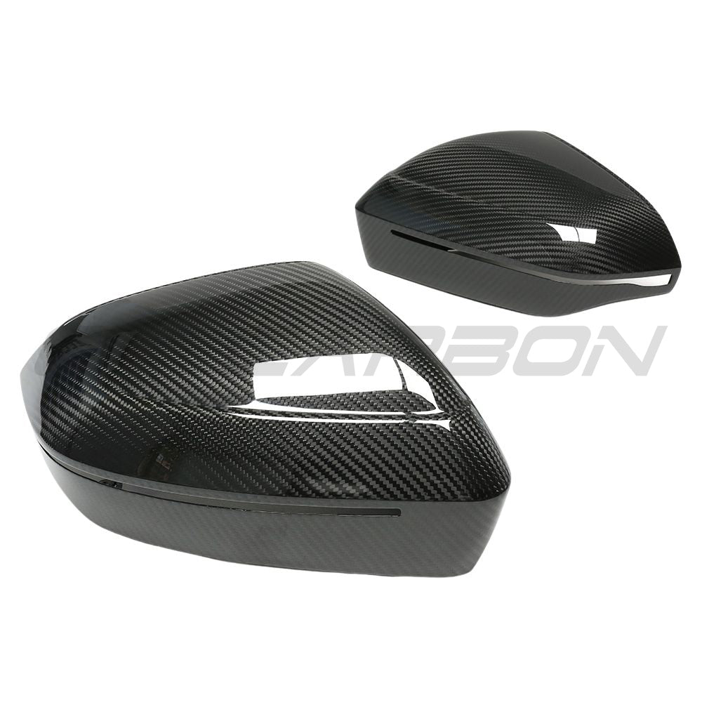 BMW M5 G90 and 5 Series carbon fiber side mirror accessories by CT Carbon, left-hand drive, showcasing sleek pre-preg carbon fiber design.