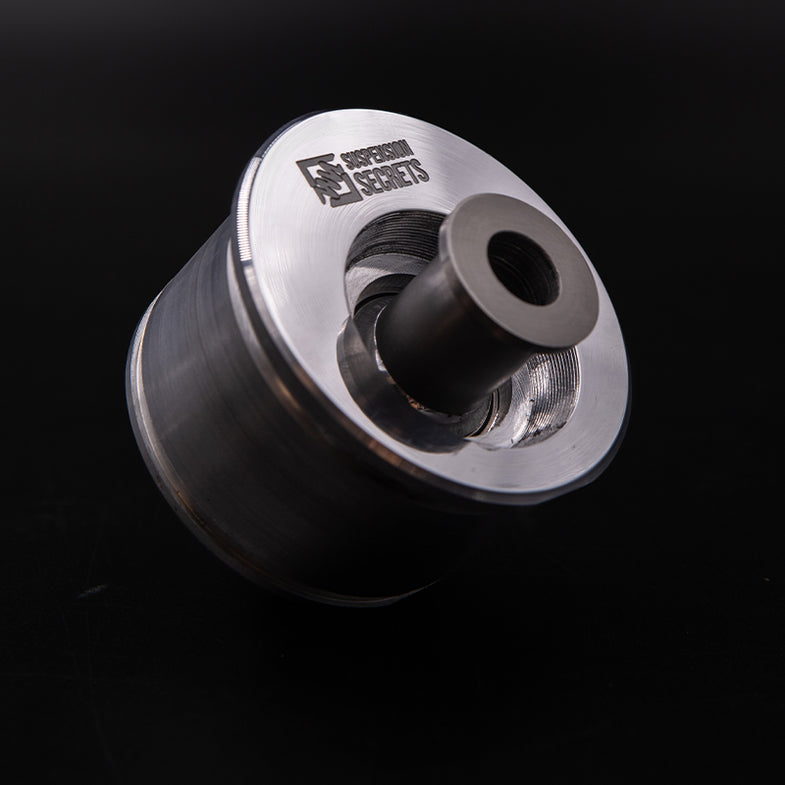 Suspension Secrets front offset caster bushes for BMW G87 M2, suspension linkage components with black rubber and metal parts.