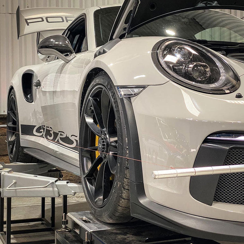 Suspension Secrets rear camber shim kit for Porsche 911 (991) GT3, RS, GT2, RS, showing metal suspension linkages and shim components.