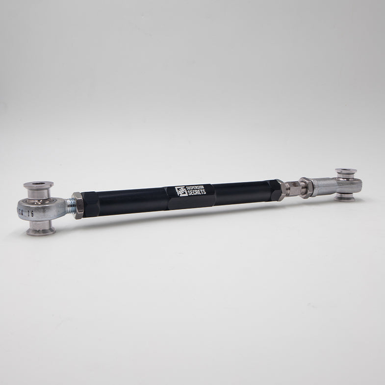 Suspension Secrets adjustable rear traction arms for BMW G87 M2, showing metal linkage components with mounting points.