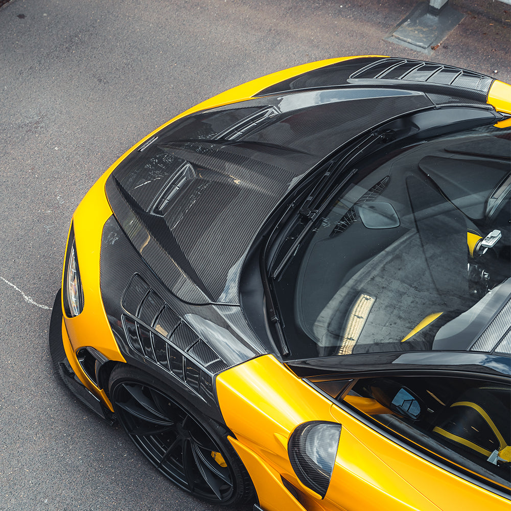 CT Carbon McLaren 720S carbon fibre front fenders showing sleek, aerodynamic design and glossy finish on a white background.