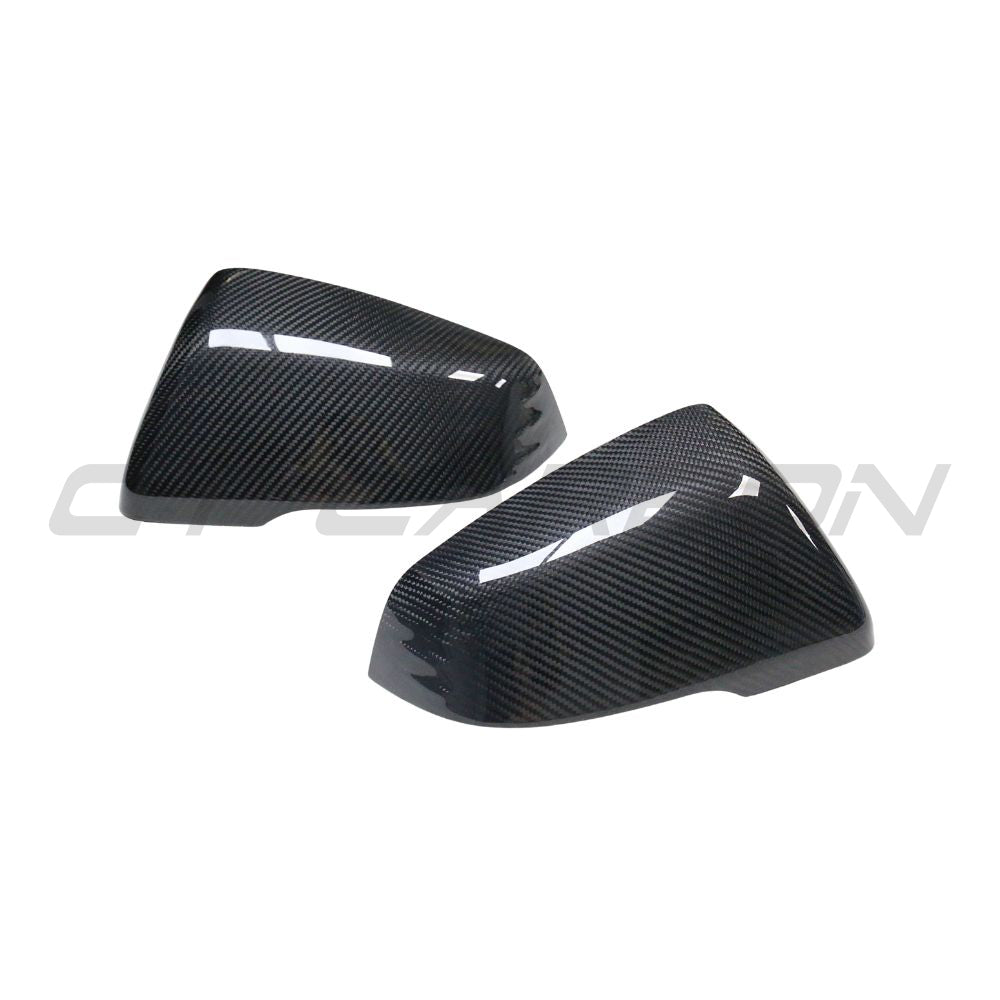 Toyota Supra A90 carbon fiber mirrors from CT Carbon, close-up view of sleek, aerodynamic car accessories on a sports car.