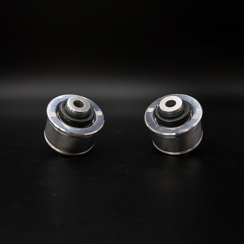 Suspension Secrets solid front control arm bushes for BMW G87 M2, close-up of black rubber suspension linkage components.