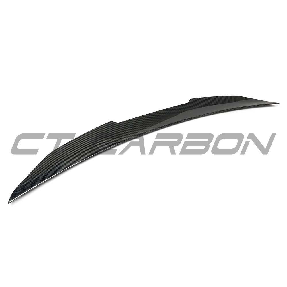 BMW G60 2023+ CT Carbon dry carbon fibre spoiler mounted on the rear of the vehicle, showcasing sleek, aerodynamic design.
