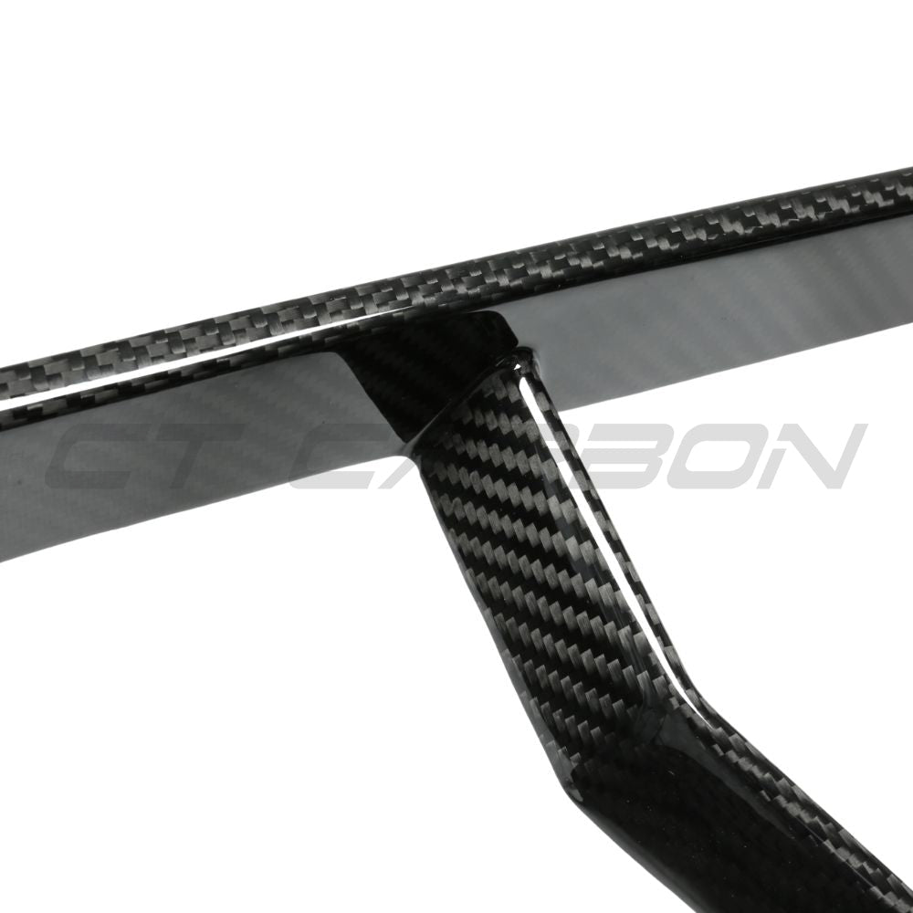 BMW G87 M2 carbon fiber lower grille accessory by CT Carbon, showcasing sleek black textured finish on the car's front lower bumper.