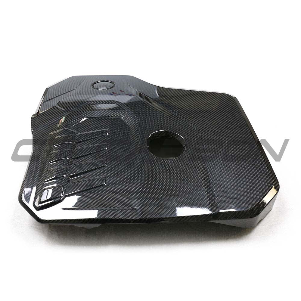 BMW G42 2 Series 2022+ dry carbon fiber engine cover by CT Carbon, showcasing sleek, textured carbon fiber surface.
