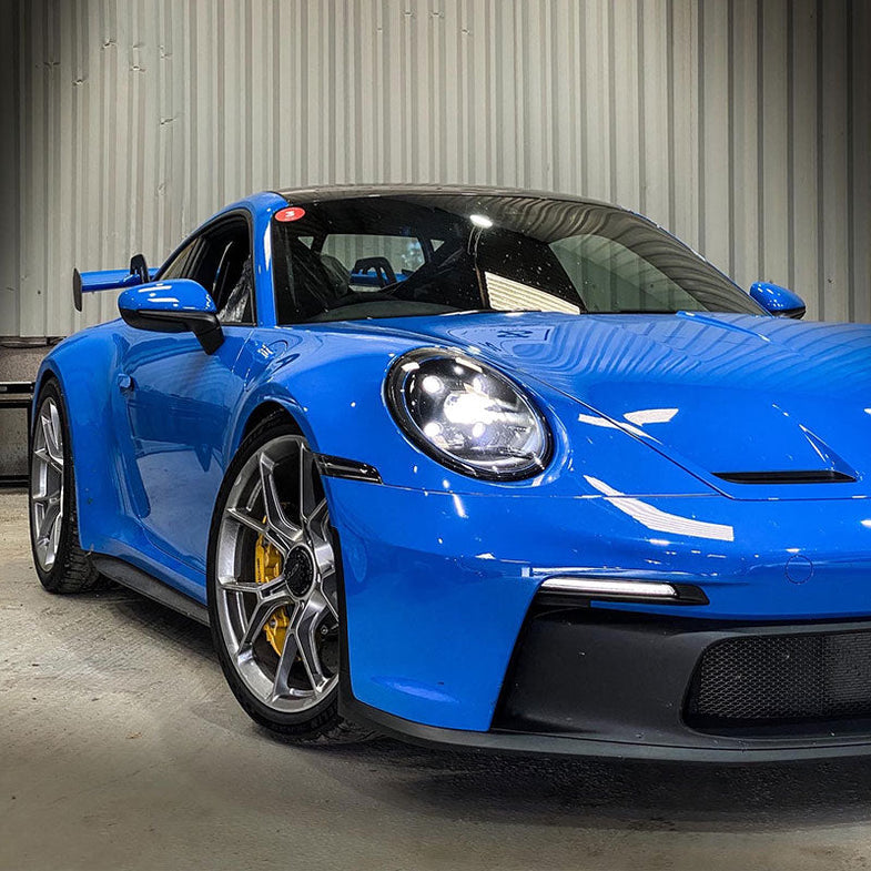 Suspension Secrets rear camber shim kit for Porsche 911 GT3 (992), featuring suspension linkages and adjustable camber components.