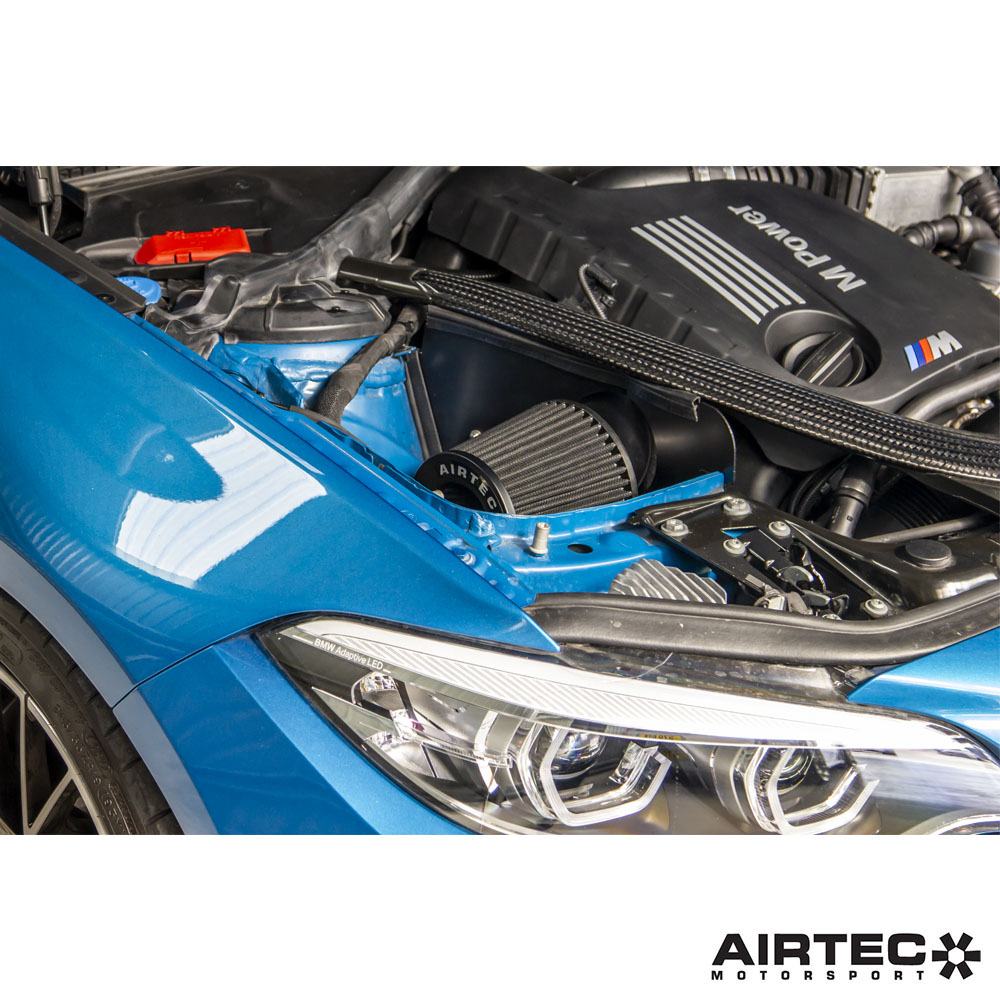Airtec Motorsport induction kit installed in a BMW M2 Competition, M3, and M4, featuring high-performance air intake components.