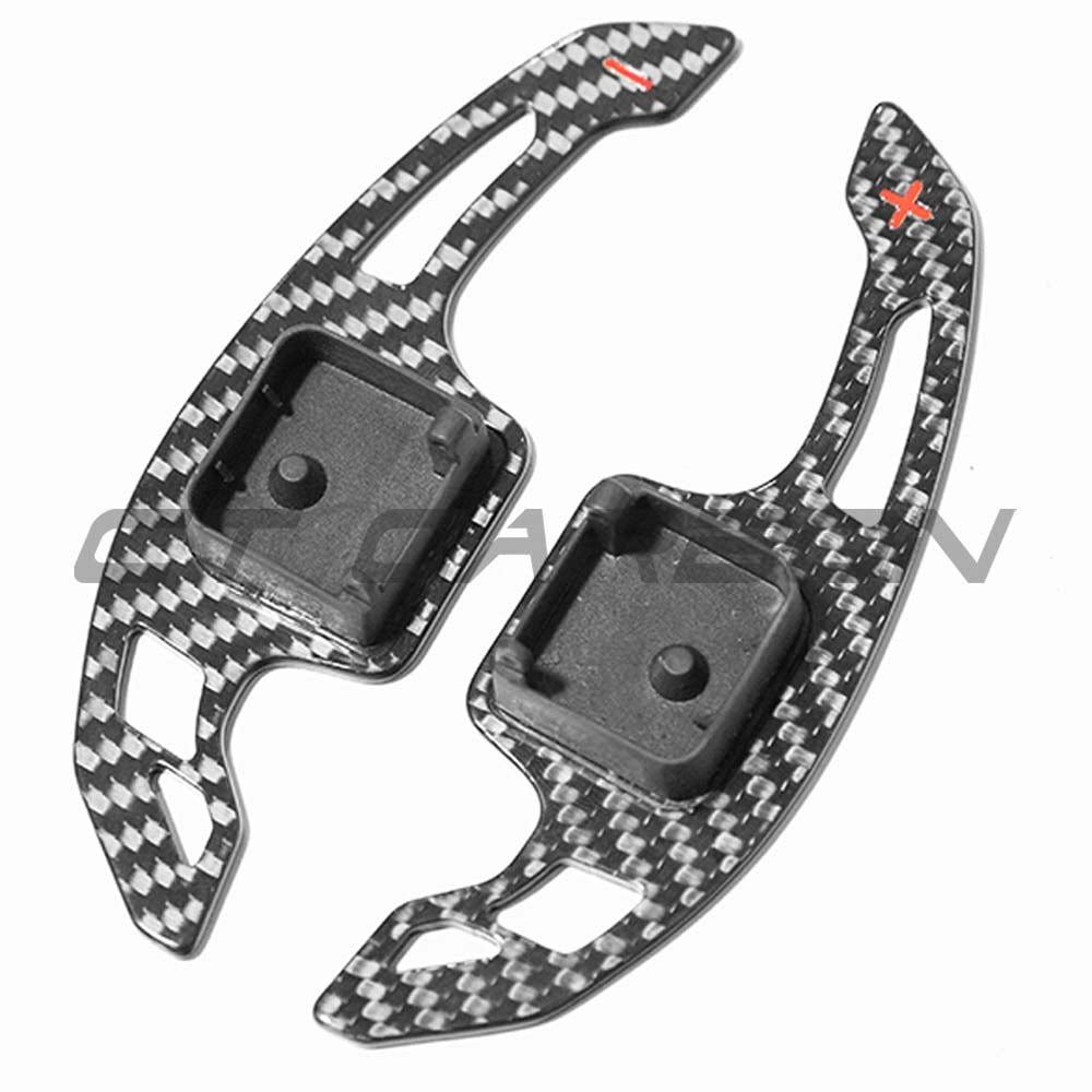 Carbon fiber shifter paddles for Audi A3, S3, RS3, RS6 C8 from CT Carbon, with a sleek V3 design, shown on a car steering wheel.